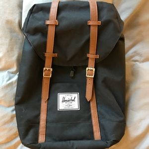 A black Herschel backpack.